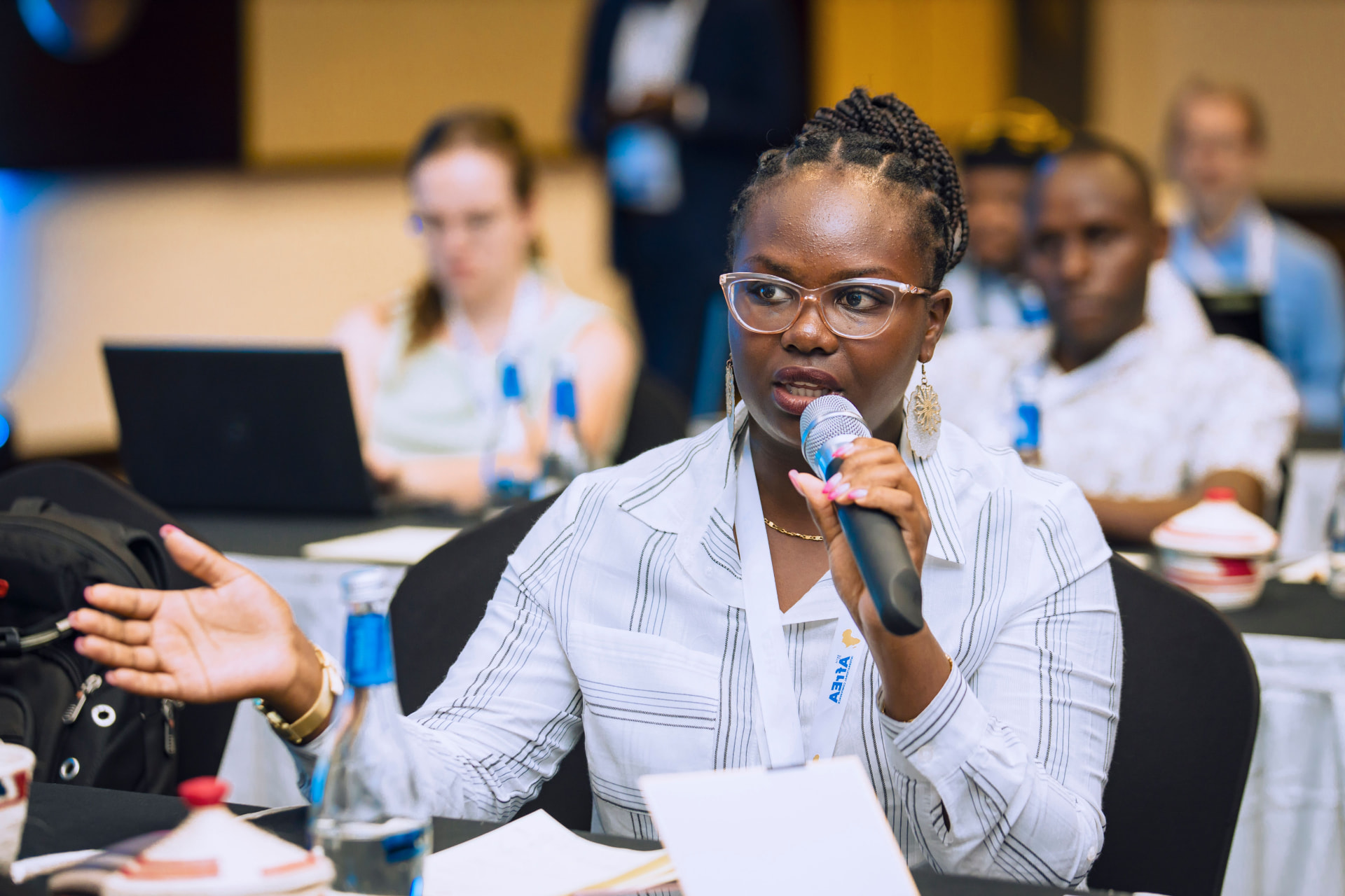 A South African woman speaking at a community forum